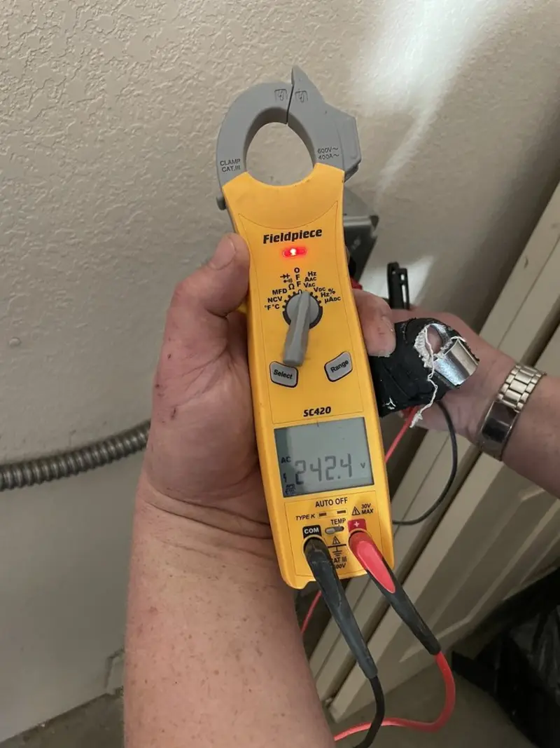 Voltage testing with clamp meter during Outlet Installation in Burton